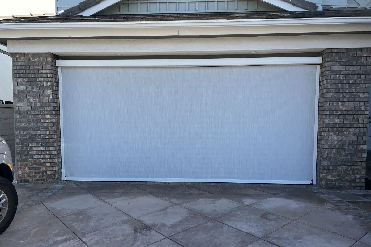 Apollo factory-trained technician installing motorized garage door screen