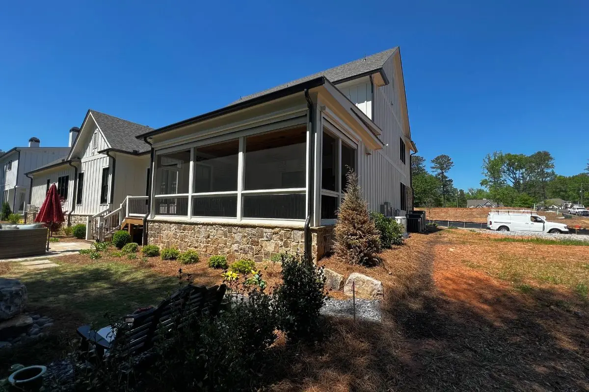 Motorized outdoor shades installed on a covered patio with zip-track side channels - Apollo Screen & Shade