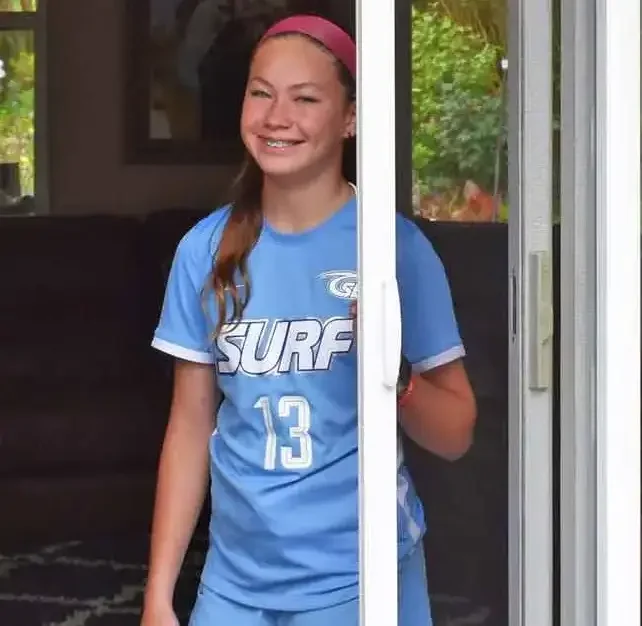 Girl pulling an Apollo retractable screen across a sliding glass patio door